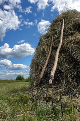 stack of hay and pair of pitchfork