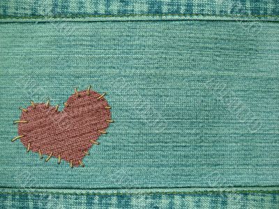 Background the heart attached by threads to jeans Background the heart attached by threads to jeans