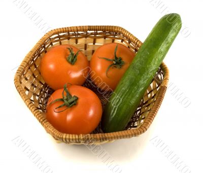 Basket with tomatoes and cucumber