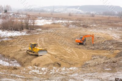 Excavator and buldozer prepare platform before construction