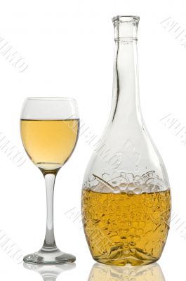 Wineglass and bottle with white wine