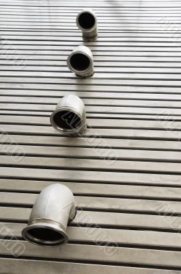 Pipes in a metal floor