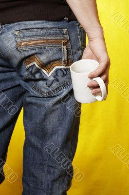 a young caucasian man with white tea cup