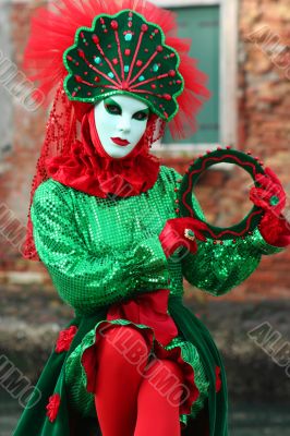 The Venetian mask in a bright green suit..