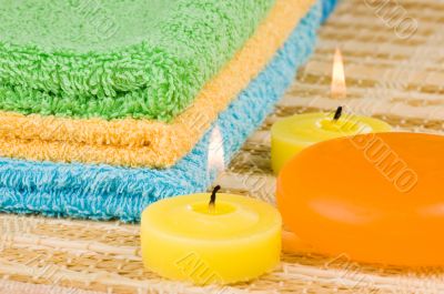 Towels of different colors soap and candles