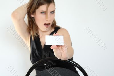 The girl holds a card