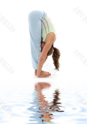 uttanasana standing forward bend on white sand