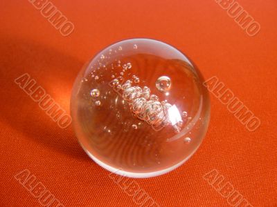 Glass sphere on a red fabric