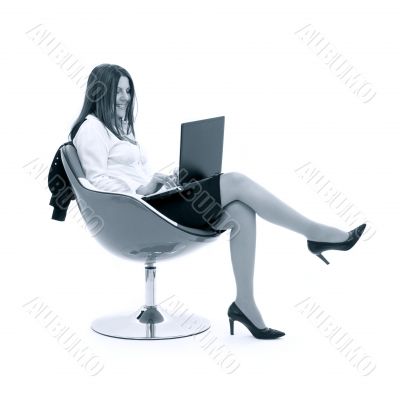 monochrome businesswoman with laptop in chair