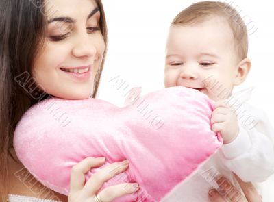 baby and mama with heart-shaped pillow