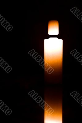 Light candle isolated on black