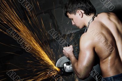 Worker cuts metal Worker cuts metal