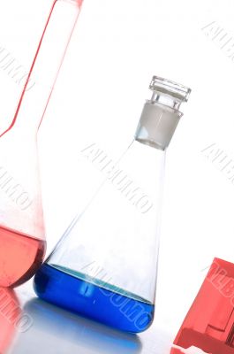 three chemical glass with blue and red liquids