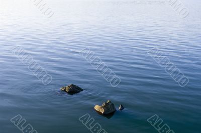 Stones in water surface Stones in water surface