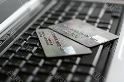 A shot of a laptop and a credit card in an office environment, can be used as e-commerce concept