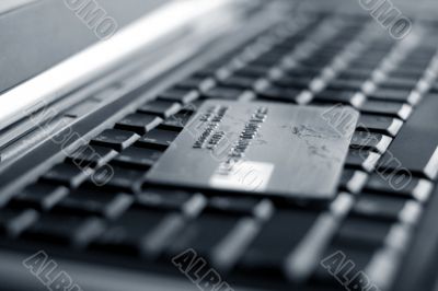 A shot of a laptop and a credit card in an office environment, can be used as e-commerce concept