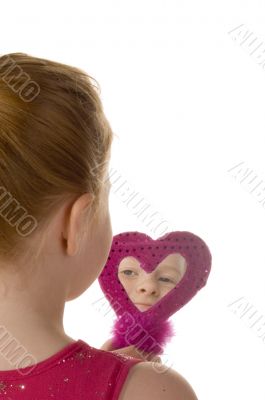 Little girl looking in a purple mirror Little girl looking in a purple mirror