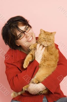 young beautiful woman holding a red domestic cat