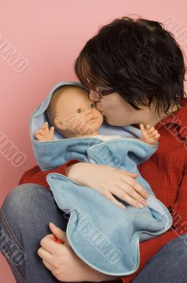 young mom kisses her baby young mom kisses her baby