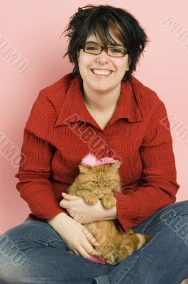 young beautiful woman holding a red domestic cat