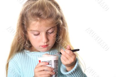 little girl looking at her yogurt