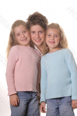 Three siblings on white vertical