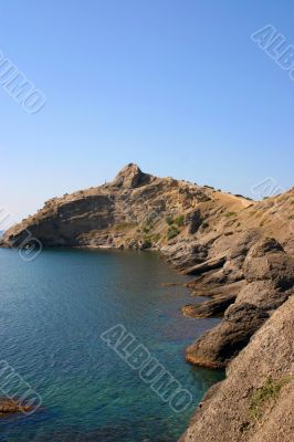 rock on by sea, blue sky