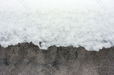 Snow over concrete wall