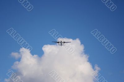 Plane on a blue and cloudy sky