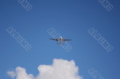 Plane on a blue and cloudy sky