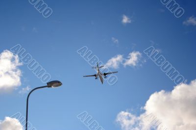 Plane on a blue and cloudy sky