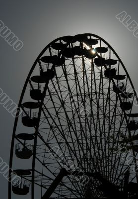 Big wheel in the evening against the sun