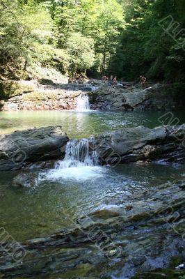 bathing in small waterfalls in granite coast