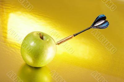 Exact hit of a dart in a golden apple