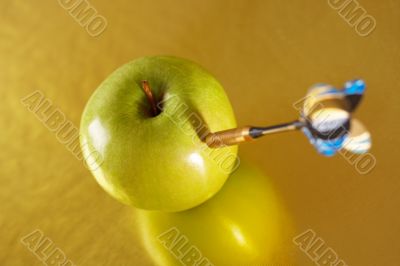 Exact hit of a dart in a golden apple