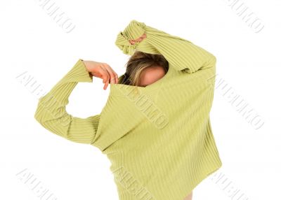 Funny girl takes off a green sweater