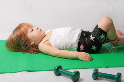 Small girl is tired to make power training.