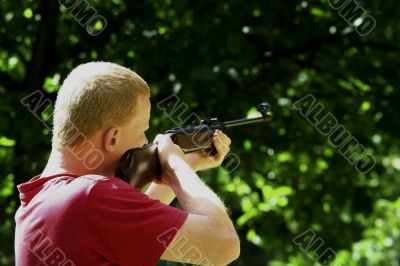 Young man with a hunting rifle