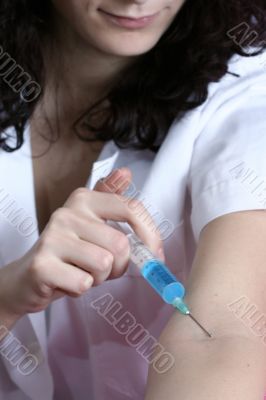 Portrait of a young doctor with syringa.