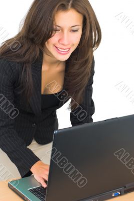 smiling girl typing on a laptop