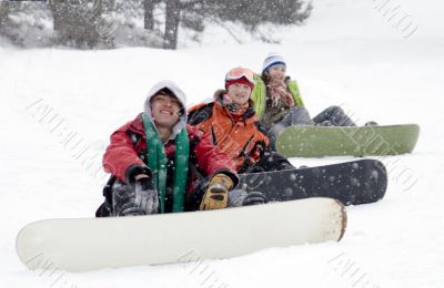 Group of teenagers snowborders in mountains