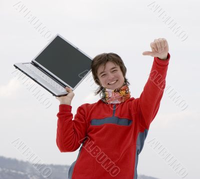 Happy teens student with laptop in hand