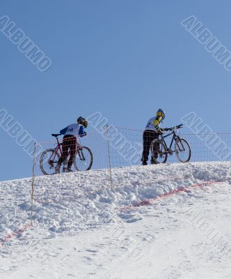 Couple of professional bikers in mountains Couple of professional bikers in mountains
