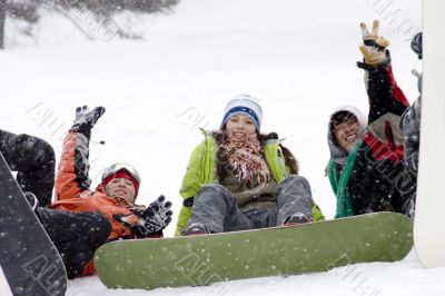 Group of sports teenagers snowborders in snow