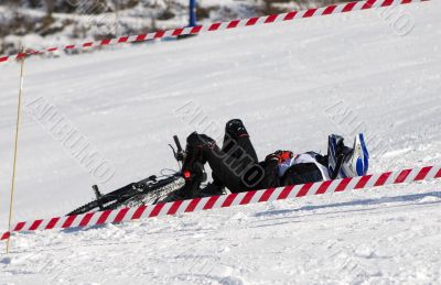 Snow biker downhill after accident in winter