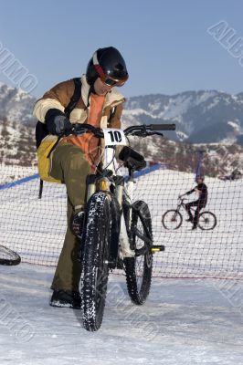 Biker in helmet in winter mountains Tien Shan