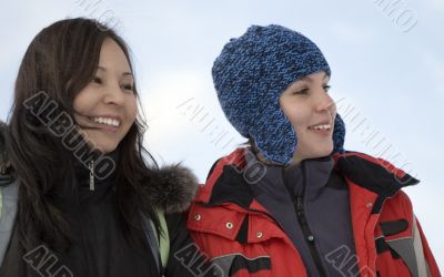 Two girls teens in sport clothes over blue