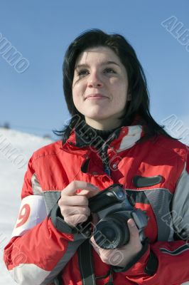 Attractive woman in sport wear holding a camera