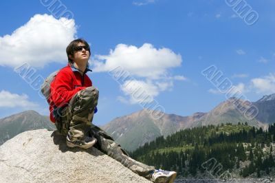 Teenager boy in sport pullover in mountain hike