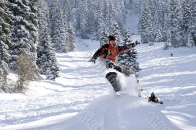 Snowboarder pull-up a sweet grab off a jump Snowboarder pull-up a sweet grab off a jump
